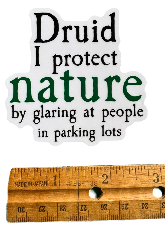 A bold, tongue-in-cheek design built around druid energy with attitude. The word Druid stands strong at the top, grounded in earthy style, followed by the phrase:

“I protect nature by glaring at people in parking lots.”

With a ruler for size Validity